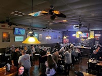 a group of people are gathered in a bar