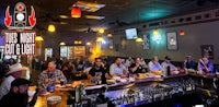 a group of people sitting at a bar